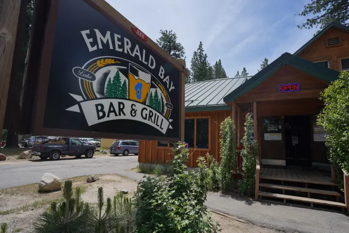 The Emerald Bay Bar & Grill sign and cabin exterior on Emerald Bay Road