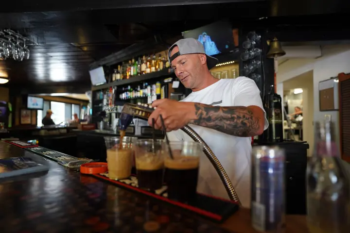 Pouring beers behind the bar