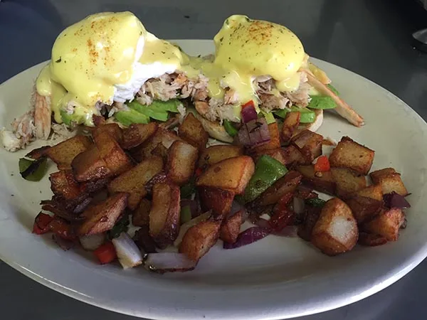 Crab and avocado benedict with homefries